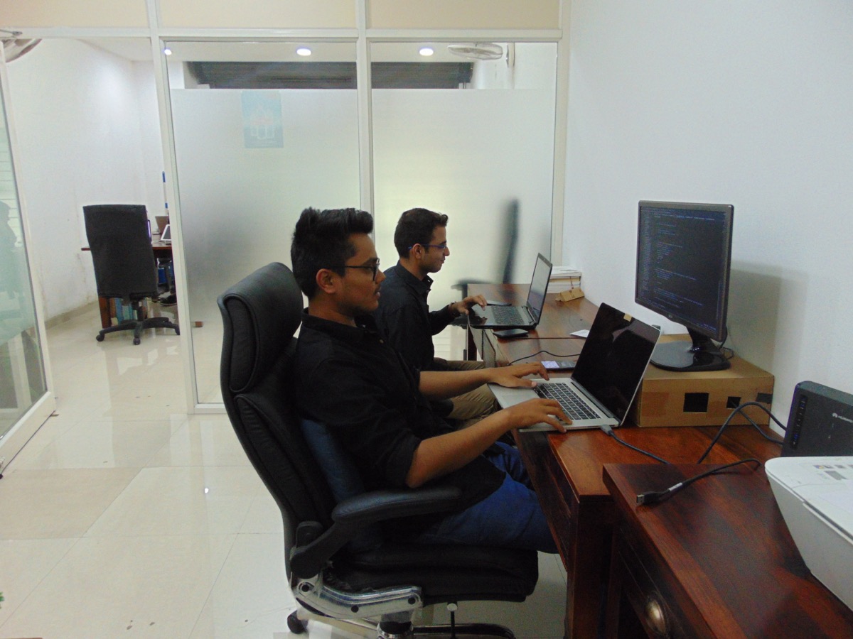 Two engineers heads-down at their desks.
