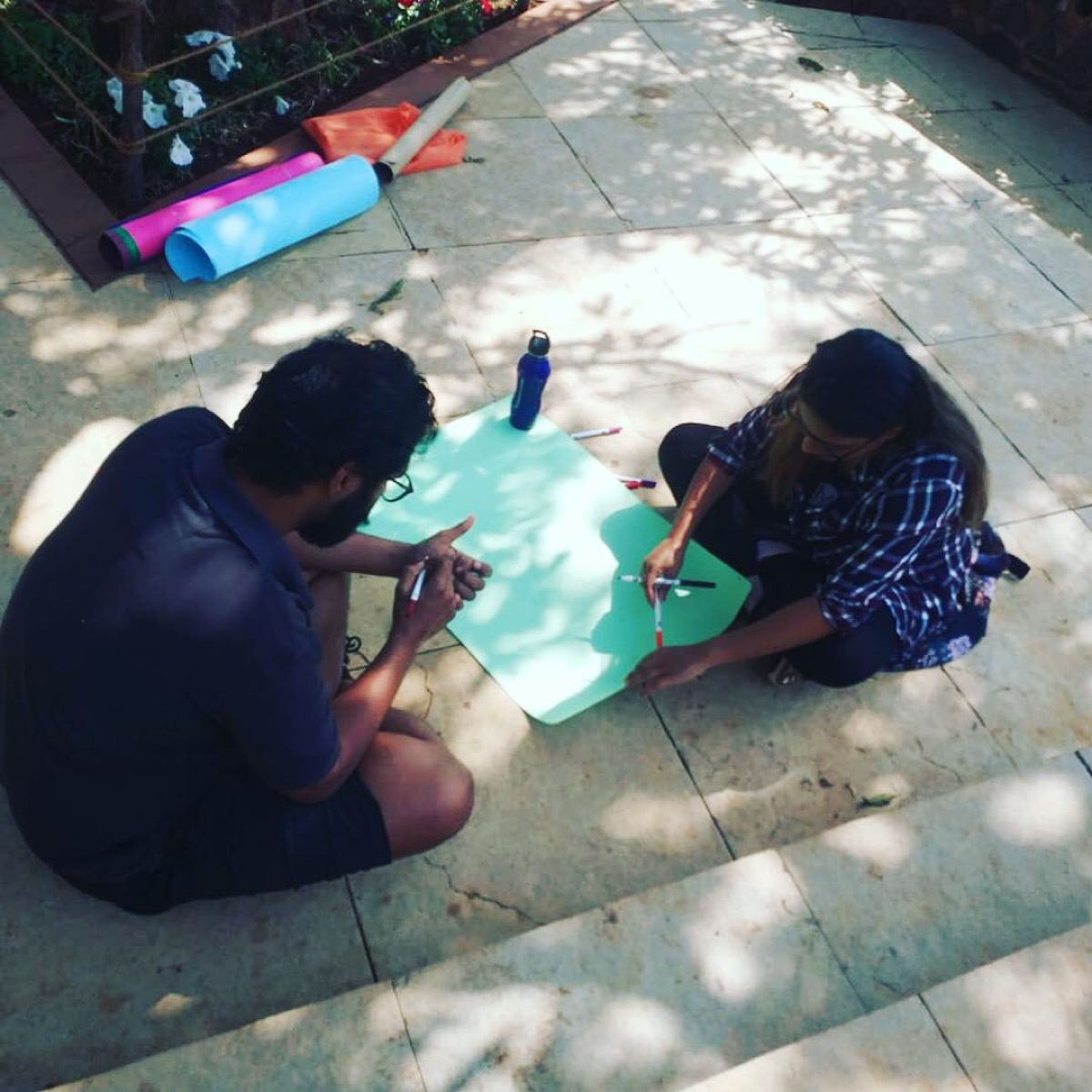 Two team members sketching together at an offsite.