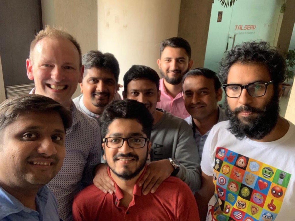 A group selfie of the India team with a European colleague.