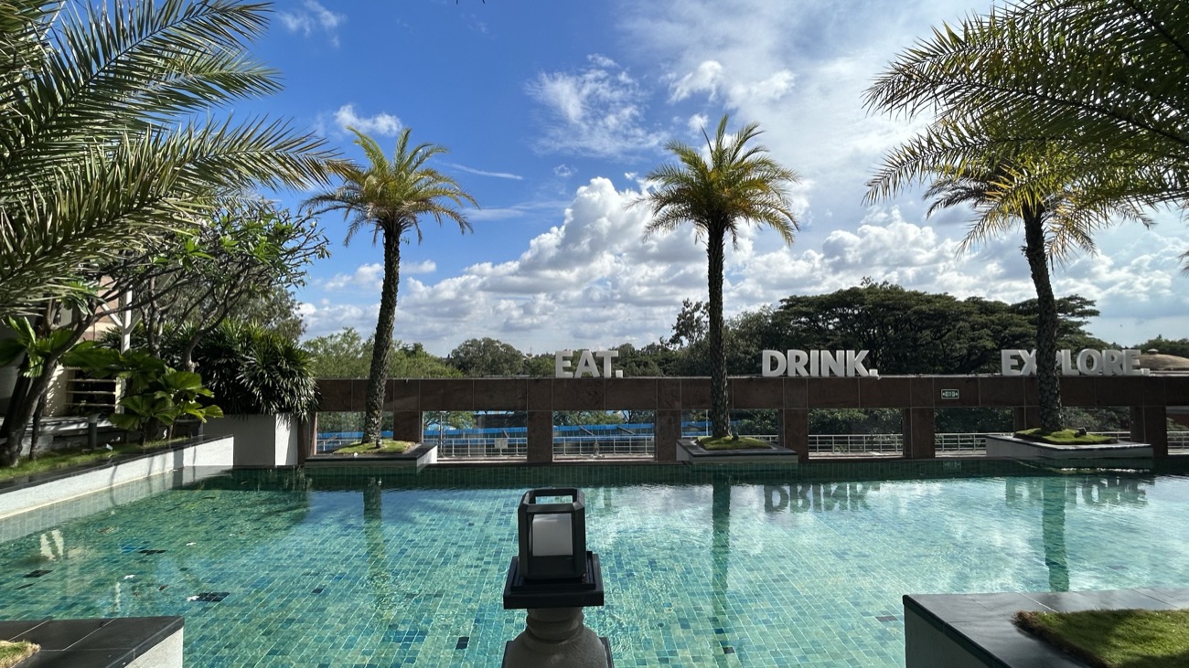 A resort poolside with EAT DRINK EXPLORE signage on a team offsite.